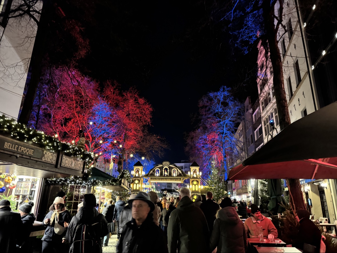 Cologne Christmas market trees lit in red and blue at night