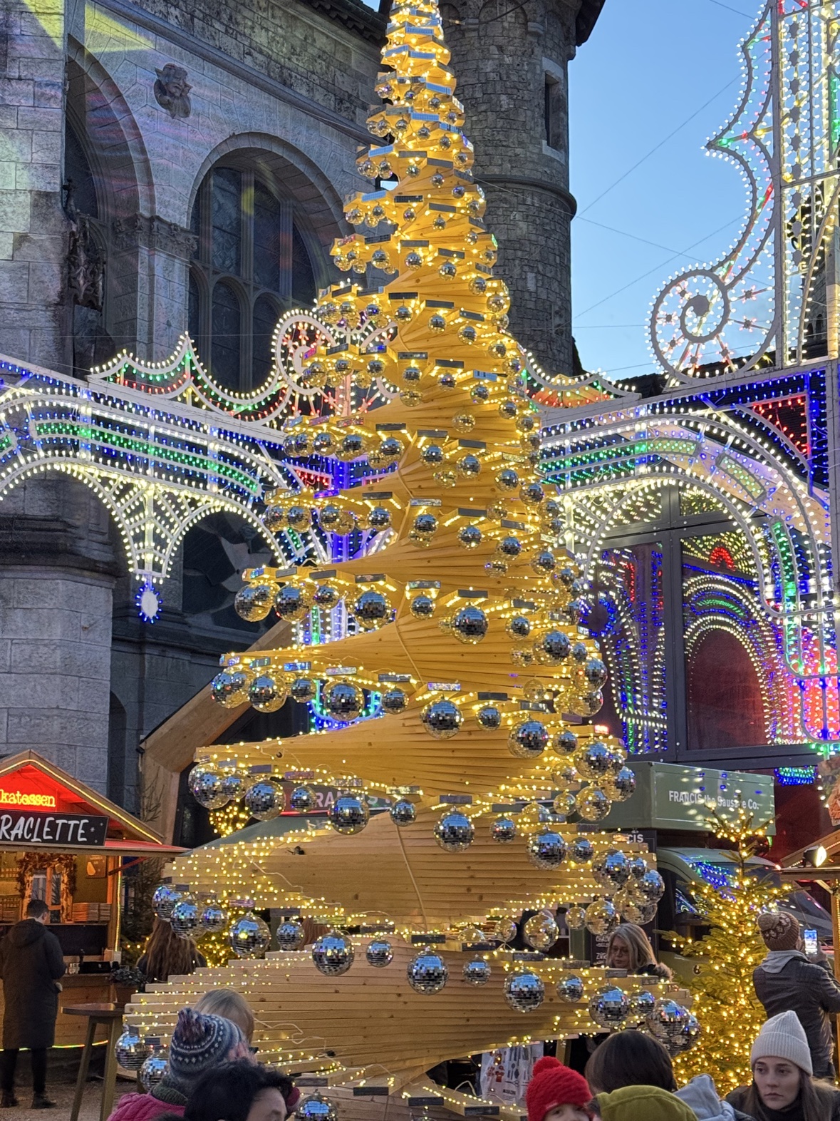 The Illuminarium's wooden spiral Christmas tree hung with mirror balls, Zurich