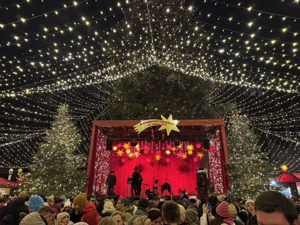 The stage and Christmas tree under a canopy of lights at the Cologne Christmas market