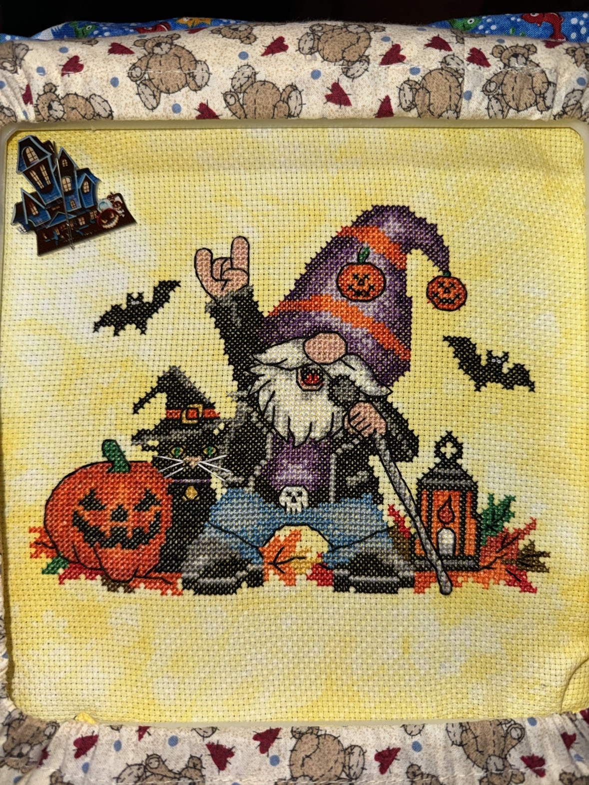 Kathy&rsquo;s finished cross-stitch, &ldquo;Totally Rocking Halloween&rdquo; by Michaela Learner — a rock-on gnome with a microphone stand and a black cat in a witch hat