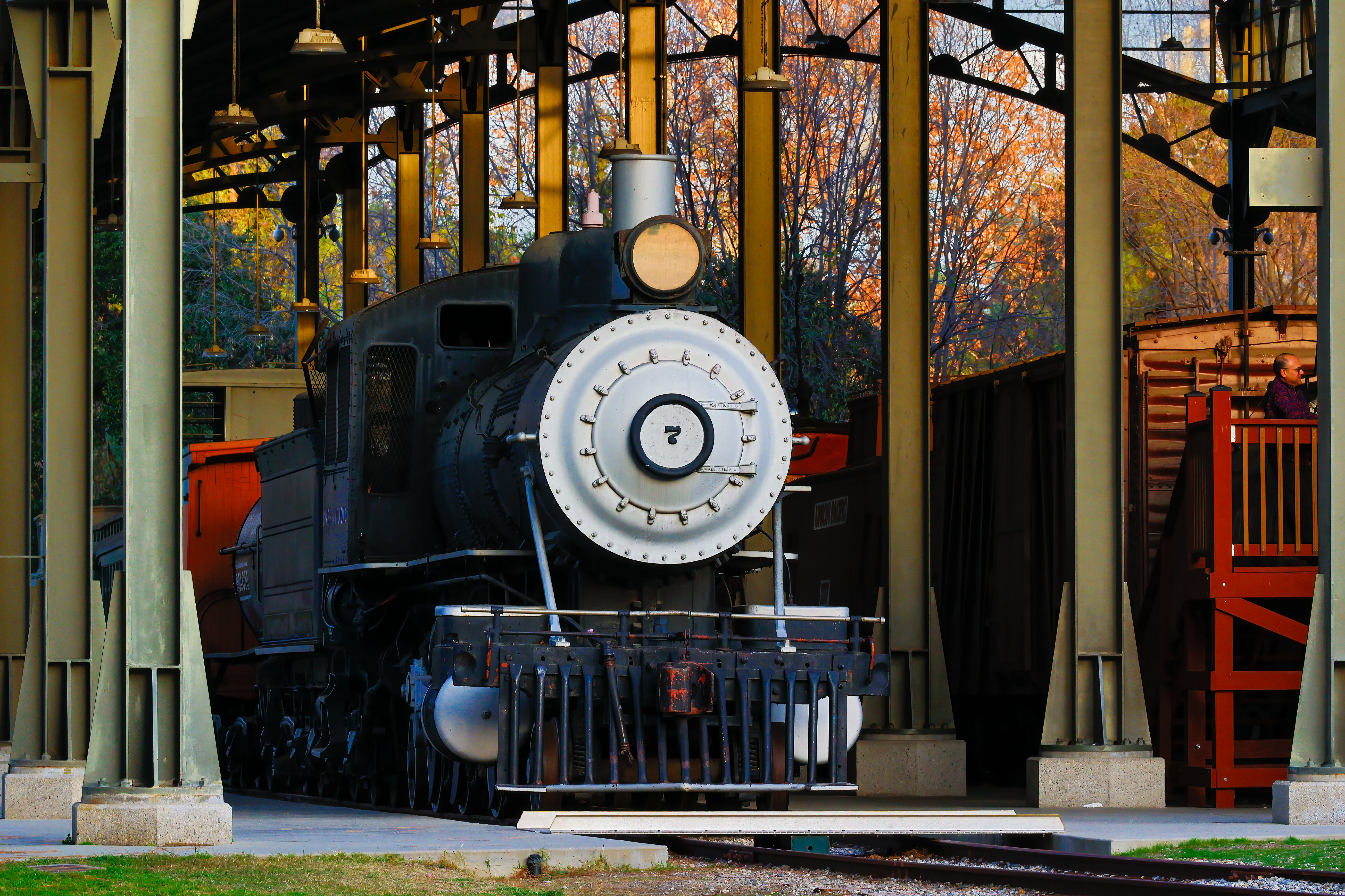 A classic black steam locomotive at a historic train station